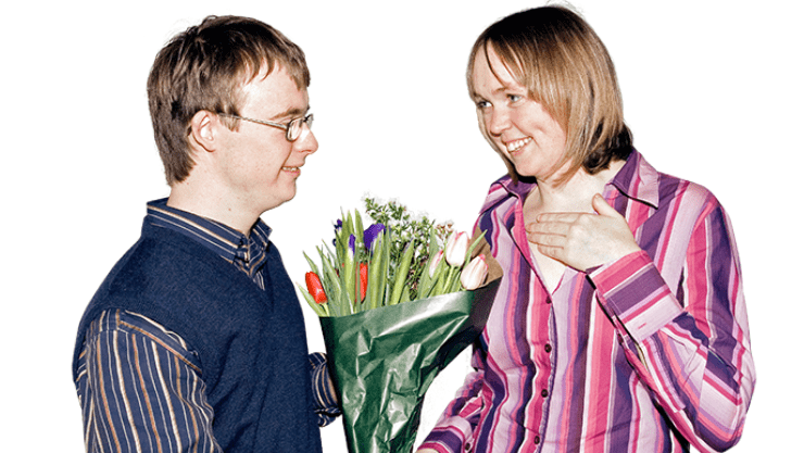 a man offering flowers to a woman on their first date