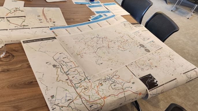 Bus route maps on a table.