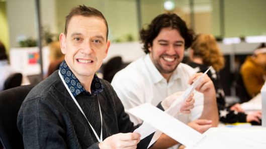 A man with intellectual disability works with his supervisor.