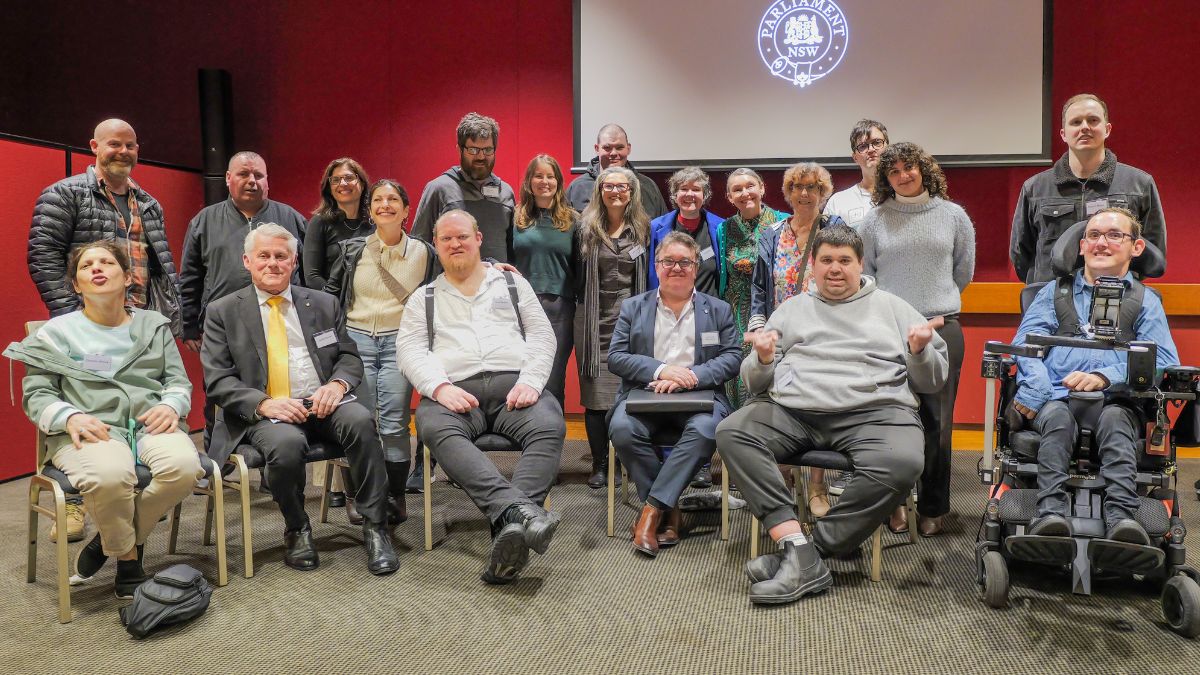 A group of people posing for a photo. The people include NSW legislators, CID staff members, and members of the CID advocacy group.