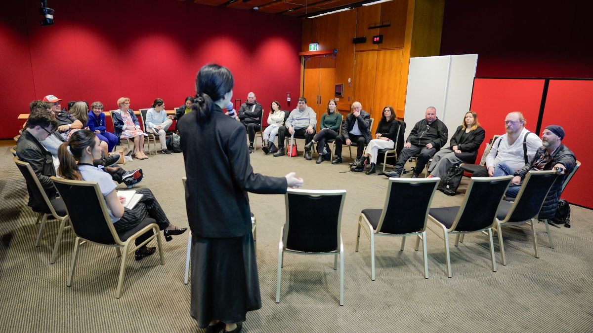 A group of people sitting in chairs in a circle. The people include NSW legislators, CID staff members, and members of the CID advocacy group.
