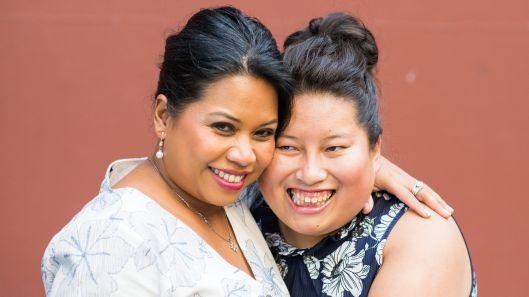 A mother hugging her daughter with intellectual disability.
