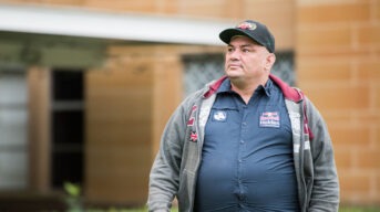 A man with intellectual disability standing outside a court building
