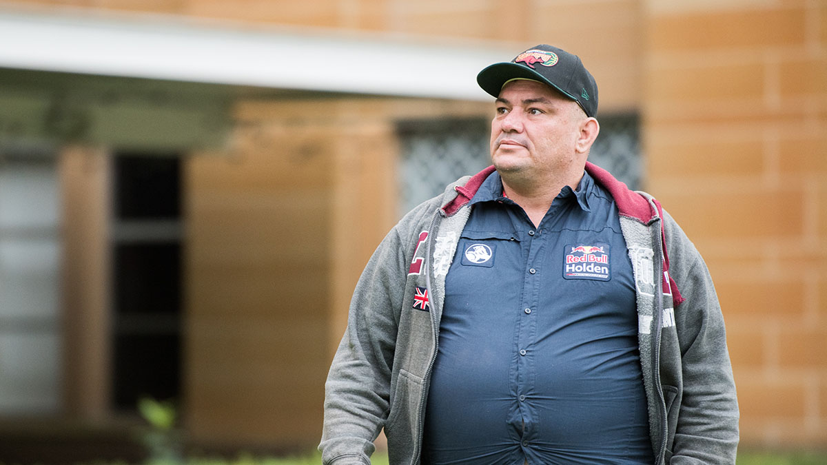 A man with intellectual disability standing outside a court building