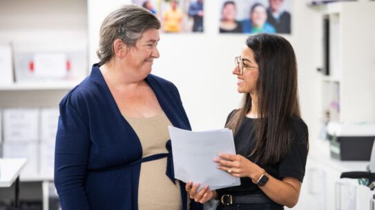 A woman with intellectual disability talks to a supporter.